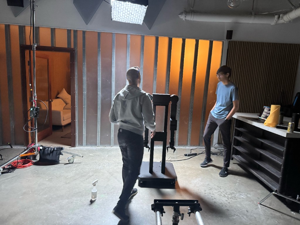 AlmondBot founders positioning the robotic arm on the rented location
